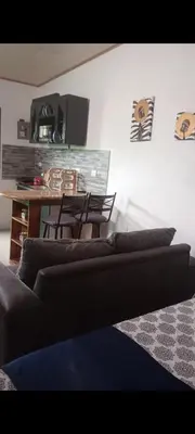 a living room with a couch and a table at Wileri in Tapantí