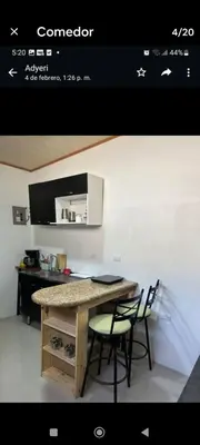 a kitchen with a table with chairs and a counter at Wileri in Tapantí