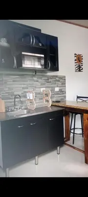 a kitchen with a sink and a microwave at Wileri in Tapantí