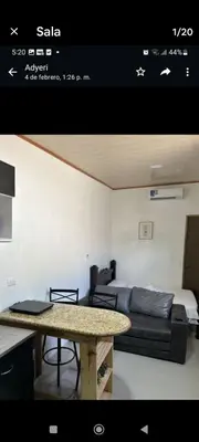 a living room with a table and a couch at Wileri in Tapantí