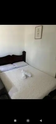 a bedroom with a bed with a towel on it at Wileri in Tapantí