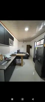 a kitchen with a table in the middle of a room at Wileri in Tapantí
