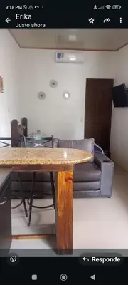 a living room with a table and a couch at Wileri in Tapantí