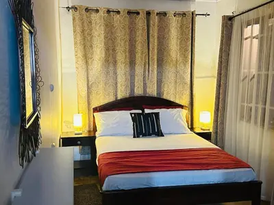 a bedroom with a bed with red and white pillows at Casa de Campo en Rivas de Pérez Zeledon in Rivas