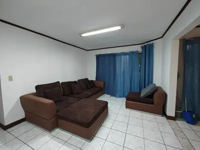 a living room with a couch and two chairs at House in Rohrmoser near the National Stadium of CR in San José