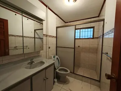 a bathroom with a sink and a toilet and a shower at House in Rohrmoser near the National Stadium of CR in San José