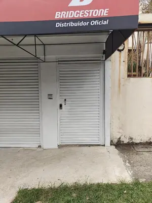 a garage door of a building with aldergroppel at House in Rohrmoser near the National Stadium of CR in San José