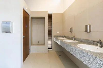 a bathroom with three sinks and a row of mirrors at Viva Jaco II in Jacó