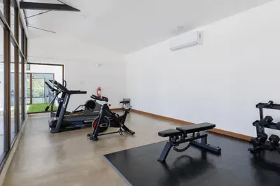 a gym with several exercise bikes in a room at Viva Jaco II in Jacó
