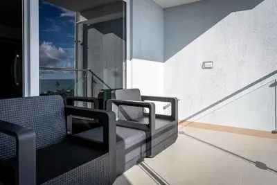 a balcony with chairs and a view of the ocean at Viva Jaco II in Jacó