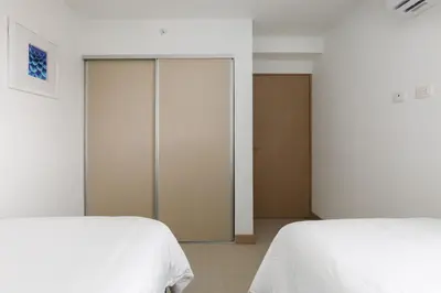 a bedroom with two beds and a sliding door at Viva Jaco in Jacó