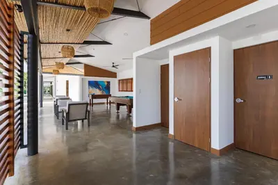 a hallway with a dining room and a dining table at Viva Jaco in Jacó