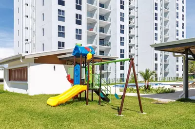 a playground in front of a apartment building at Viva Jaco in Jacó
