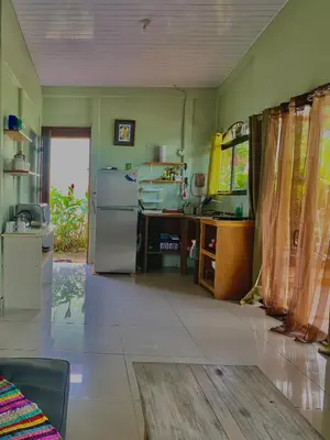 a kitchen with a refrigerator and a table at Casa mariposa in Uvita