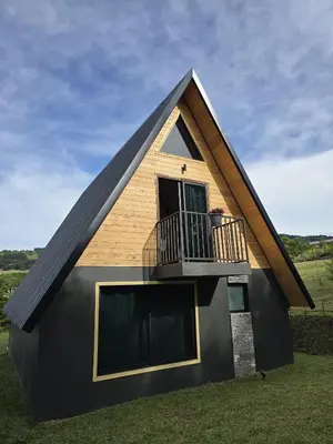 a house with a gambrel roof and a balcony at Monteluna Fraijanes in Poasito