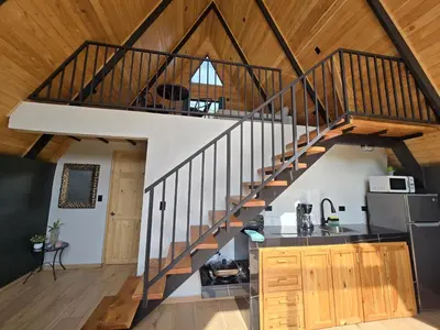 a kitchen with a staircase in a house at Monteluna Fraijanes in Poasito