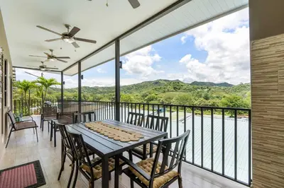 a dining room with a table and chairs on a balcony at Modern Home with Lush Mountain Views and Spectacular Shaded Terrace in Private Gated Community in Potrero