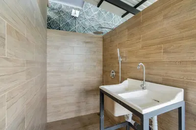 a bathroom with a sink and wooden walls at Modern Home with Lush Mountain Views and Spectacular Shaded Terrace in Private Gated Community in Potrero