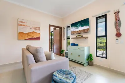a living room with a couch and a table at Modern Home with Lush Mountain Views and Spectacular Shaded Terrace in Private Gated Community in Potrero