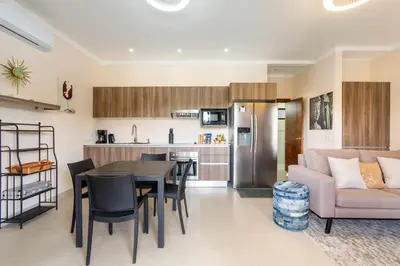 a kitchen and living room with a table and a couch at Modern Home with Lush Mountain Views and Spectacular Shaded Terrace in Private Gated Community in Potrero