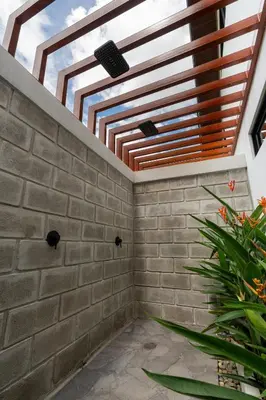 a room with a brick wall and a skylight at Villa Bosque CR in Turrialba