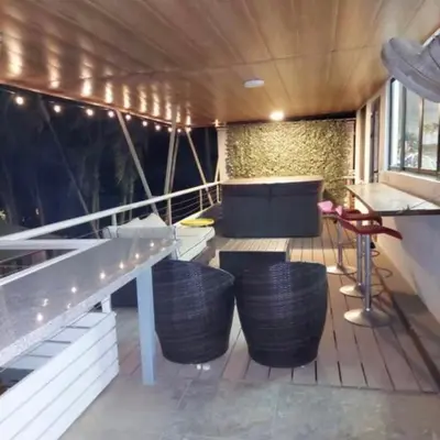 a balcony with a table and chairs on a boat at Casa Nosara a 10 minutos de las playas en auto in Nosara