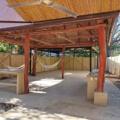 a large wooden pavilion with a hammock in it at Casa Nosara a 10 minutos de las playas en auto in Nosara