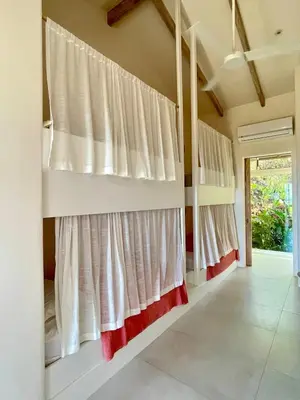 a bedroom with white curtains on the wall at Casa Niri in Nicoya