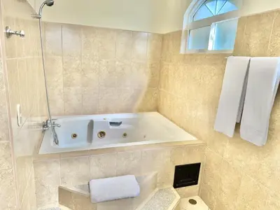 a bathroom with a bath tub with a sink at Paradise Beach Apartment Herradura in Herradura