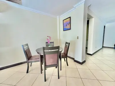 a dining room with a table and four chairs at Paradise Beach Apartment Herradura in Herradura
