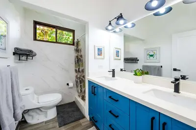 a bathroom with two sinks and a toilet and a window at Private Patio Villa, Pool Access near Playa Penca in Potrero