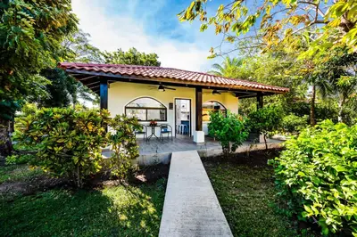 a house with a porch and a patio at Private Patio Villa, Pool Access near Playa Penca in Potrero