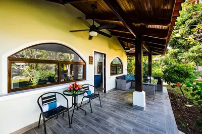 a patio with a table and chairs and a ceiling at Private Patio Villa, Pool Access near Playa Penca in Potrero