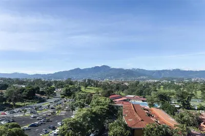 an aerial view of a city with a parking lot at Homewood Suites By Hilton Cariari San Jose in San José
