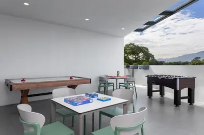 a room with a ping pong table and a pool table at Homewood Suites By Hilton Cariari San Jose in San José