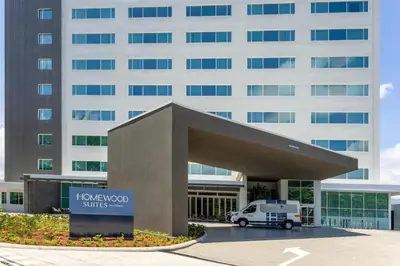 a van parked in front of a building at Homewood Suites By Hilton Cariari San Jose in San José