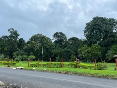 a road with a fence on the side of a field at Villa Binomio in Naranjito