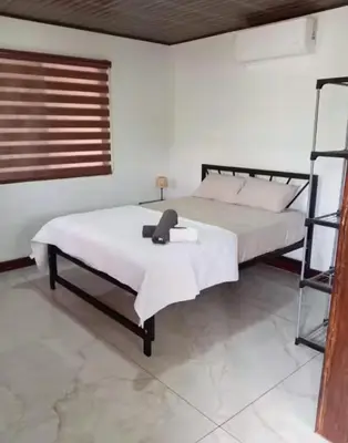 a bedroom with a large bed with a ladder at Cabina Entre Playas in Huacas
