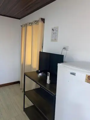 a room with a desk with a television on it at Cabina Entre Playas in Huacas