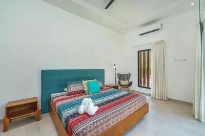 a bedroom with a bed with a stuffed animal on it at Stylish Private Tropical Escape-10 mins from Tamarindo in Villarreal