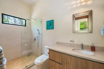 a bathroom with a toilet and a sink and a shower at Stylish Private Tropical Escape-10 mins from Tamarindo in Villarreal