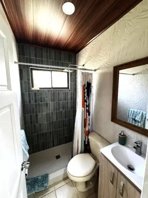 a small bathroom with a toilet and a sink at Casa Serena! in Coco