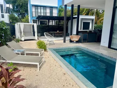 a backyard with a swimming pool and a house at Mirame #4 - 3 Bedroom Villa Across from the Beach in Coco