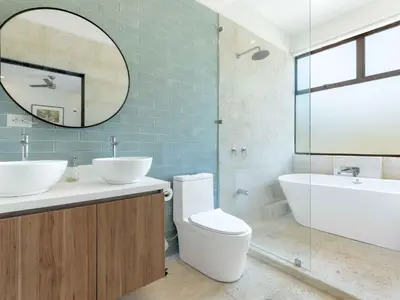 a bathroom with a toilet and a sink and a mirror at Mirame #4 - 3 Bedroom Villa Across from the Beach in Coco