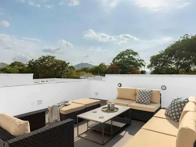 an outdoor patio with couches and a table at Mirame #4 - 3 Bedroom Villa Across from the Beach in Coco