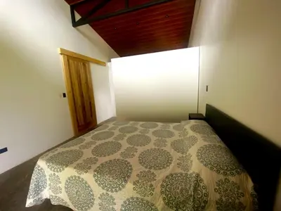a small bedroom with a bed in a room at La Casa Mokarran in Ojochal