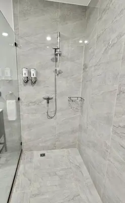 a bathroom with a shower with a glass door at Whitestone Parkview Tamarindo in Tamarindo