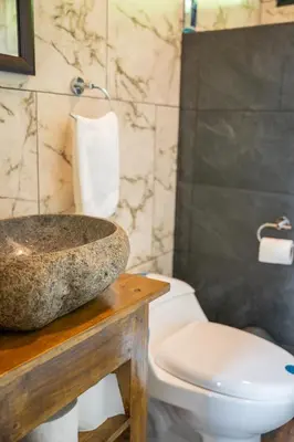 a bathroom with a sink and a toilet at Vista Canaan Cabaña de montaña in Rivas