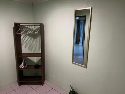 a mirror on a wall next to a shelf at Casa de Campo Nara in Fortuna