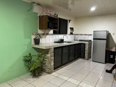 a kitchen with a sink and a refrigerator at Casa de Campo Nara in Fortuna